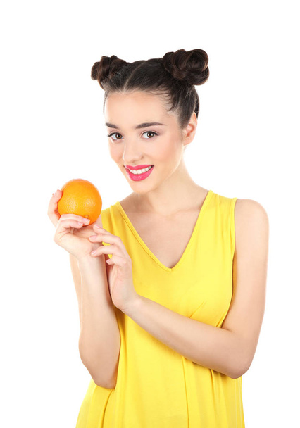 Beautiful young woman with orange on white background - Fotografie, Obrázek