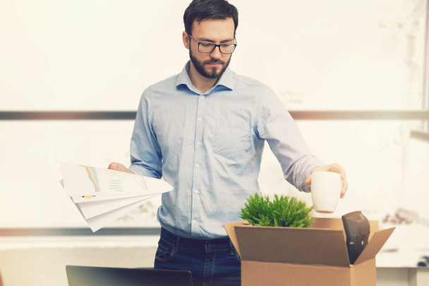job loss - fired man putting his belongings in cardboard box - Foto, Imagem