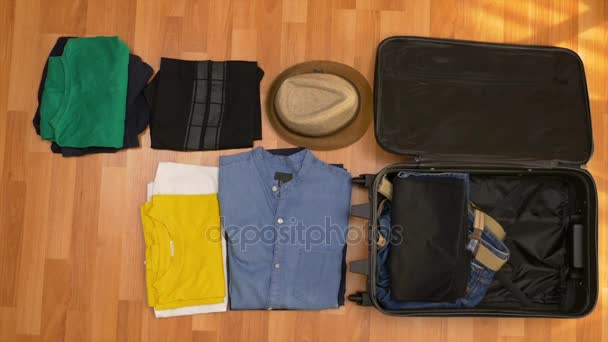 Top view timelapse of packing clothes into a suitcase - Záběry, video