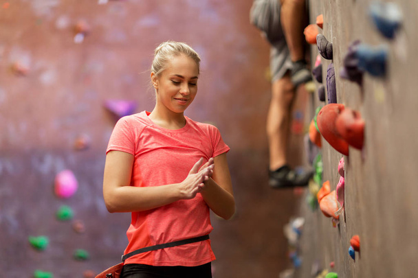young woman exercising at indoor climbing gym wall - Фото, изображение