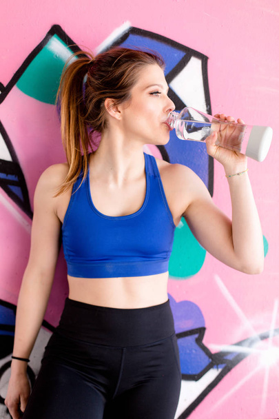 young brunette woman drinking water - Photo, Image