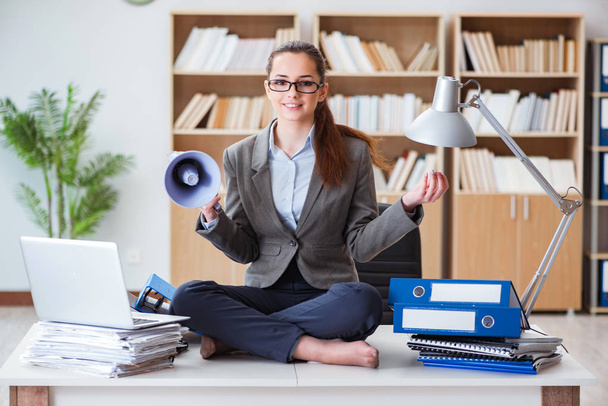 Businesswoman meditating in the office - Photo, Image