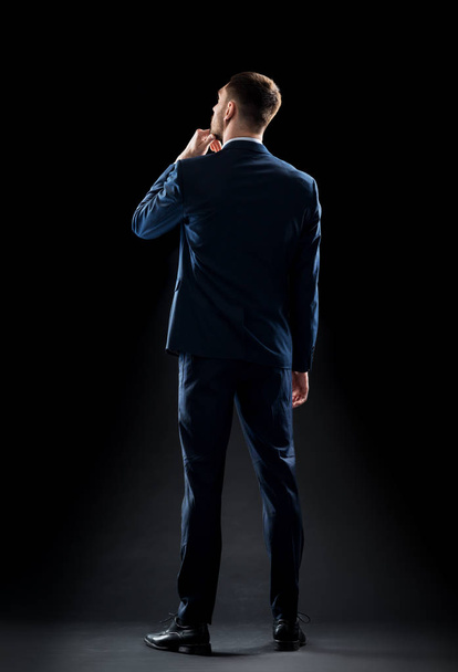 businessman in suit over black - Foto, Imagen