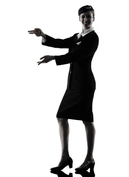 Stewardess cabin crew woman pointing silhouette - Valokuva, kuva