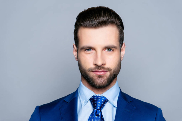 Portrait of serious fashionable handsome man in blue suit lookin - Foto, immagini