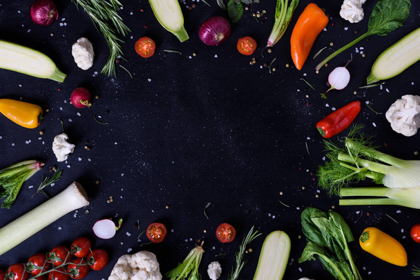 Selection of healthy vegetables and spices, veggie frame, black background. Top view, copy space.  - Fotoğraf, Görsel