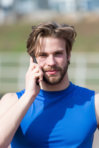 athletic bearded happy man with muscular body holds cell phone - Fotó, kép