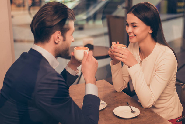 Portrait of lovely romantic couple sitting in a cafe with coffee - Фото, зображення