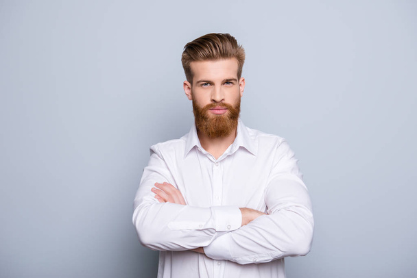 Portrait of serious confident bearded man keeping  crossed hands - 写真・画像