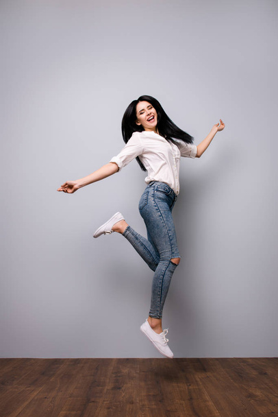 Full portrait of happy laughing jumping woman who is excited bec - Photo, image
