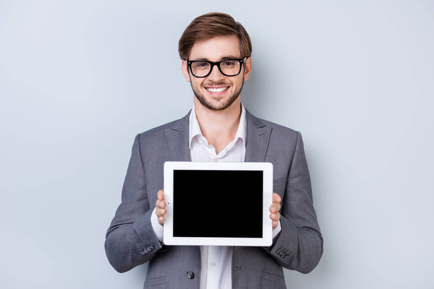 Happy young man in formal wear with smile holds digital tablet a - Foto, immagini