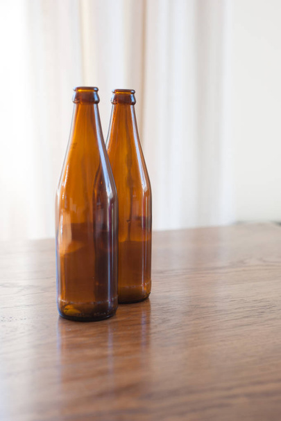 brown glass beer bottles on a table - Φωτογραφία, εικόνα