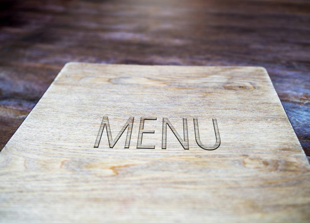 Menu book carved made by wood, in restaurant or cafe vintage decoration - Photo, Image