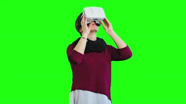 Donna che gira la testa con un visore VR acceso
. - Filmati, video