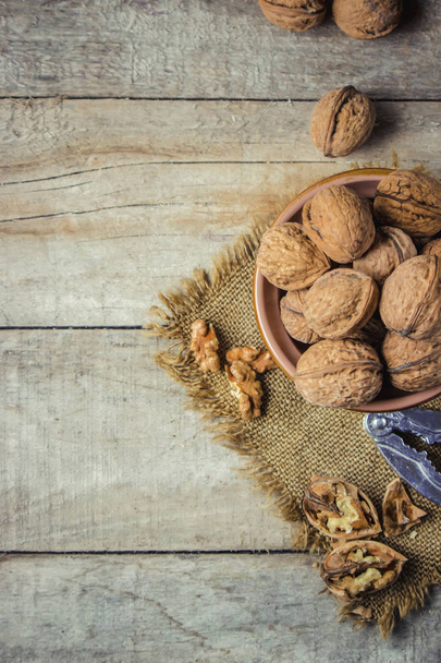 Walnuts on wooden background. Selective focus.  - Photo, image