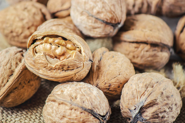 Walnuts on wooden background. Selective focus.  - Photo, Image