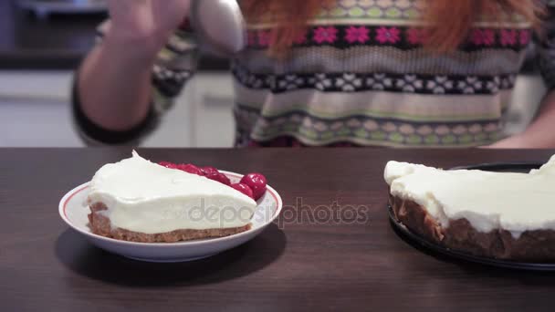 Girl adds cherries to cheese cake - Filmati, video