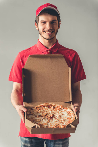 Handsome young delivery worker - 写真・画像