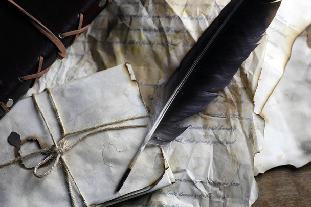 old paper letter feather - 写真・画像