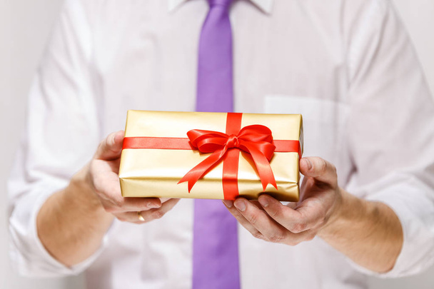 Male hands holding a gift box with ribbon. - Photo, image