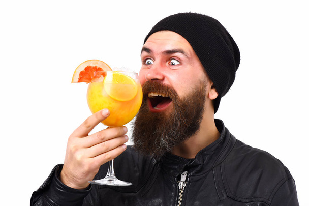 Brutal caucasian hipster holding alcoholic beverage or fresh cocktail - 写真・画像