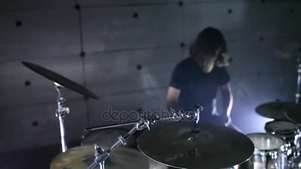 Drummer playing drums in the hangar  - Materiał filmowy, wideo