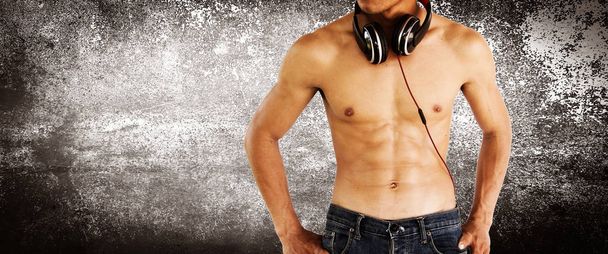 Sexy shirtless muscular male model with headphone,Healthy lifestyle concept and ideas - Foto, afbeelding