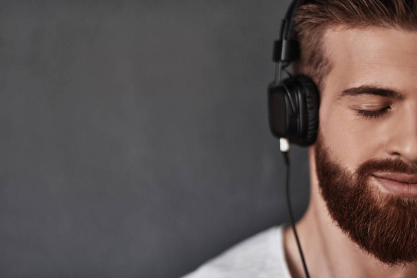 man listening music in headphones - Fotó, kép