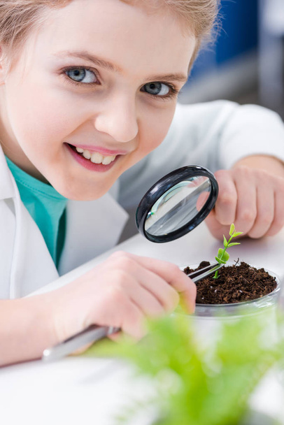 Girl with green plant in lab  - Photo, Image