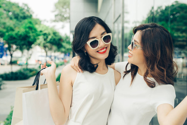 Dos chicas con bolsas de compras
 - Foto, Imagen