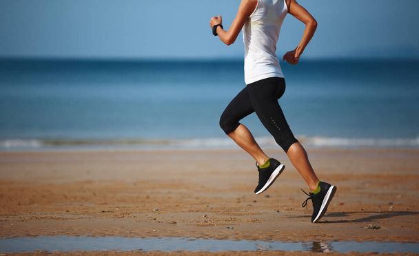 young woman running at sandy beach  - Fotoğraf, Görsel