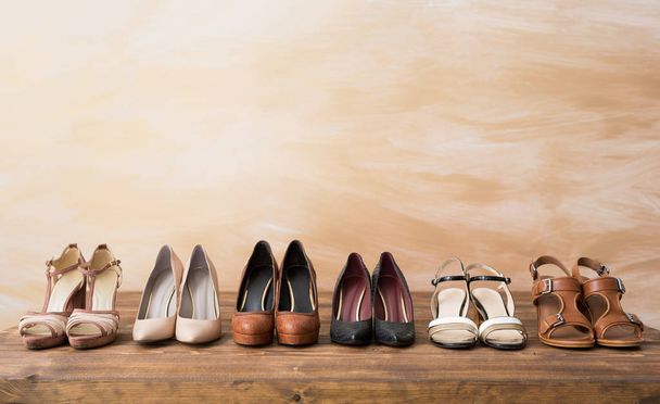 Organized woman's shoes on wooden floor - Photo, Image