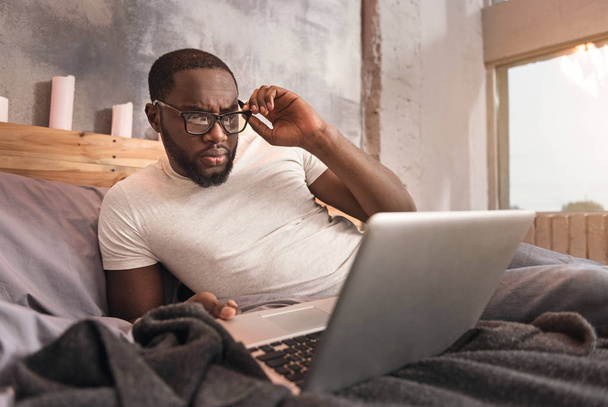 Capable young African American man working at home - 写真・画像