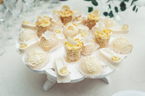 white Cakes and cupcakes on vintage white dish - Valokuva, kuva