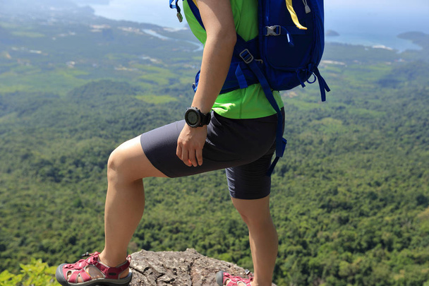  young woman standing on mountain peak - 写真・画像