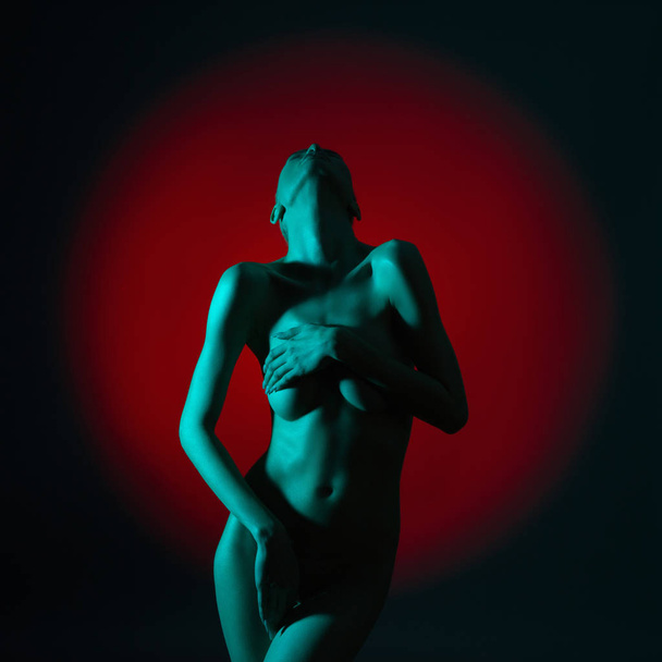 Young beautiful sexy woman with colored shadows on her body. - Foto, Imagem