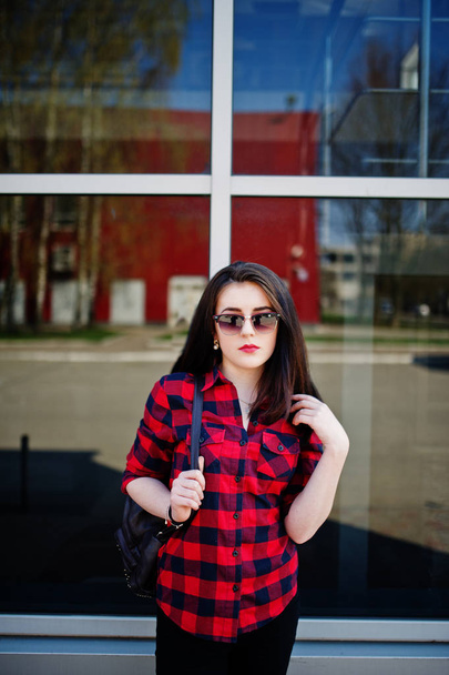 Fashion portrait girl with red lips wearing a red checkered shir - Foto, Imagen