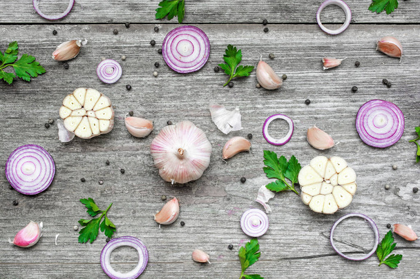 garlic, red onion, parsley and pepper on rustic wooden background - Photo, Image