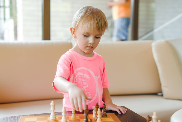 Cute little boy playing chess. - Photo, Image