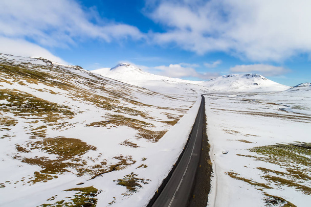 Aerial view of road and snowy mountains, Iceland - Foto, imagen