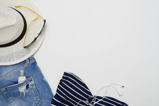 Flat lay picture of summer beach clothes with hat and headphones - Foto, Imagem