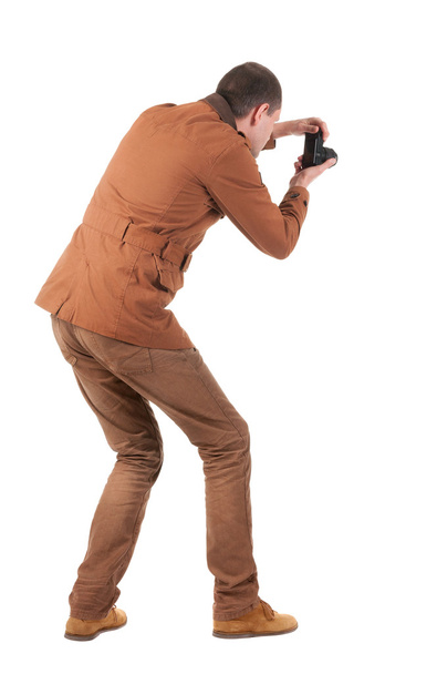 Back view of man photographing - Foto, Imagen