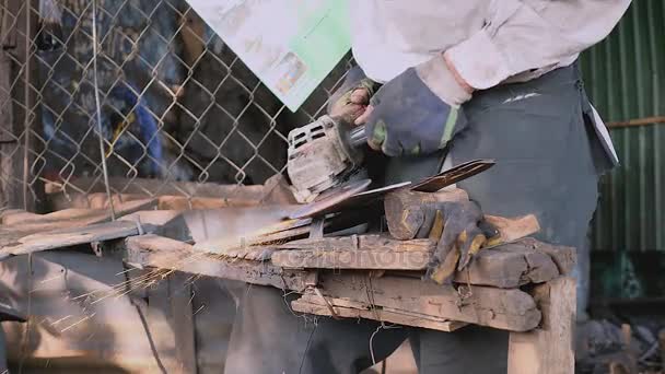  worker sharpening a traditional broad blade with a grinding wheel  - Footage, Video