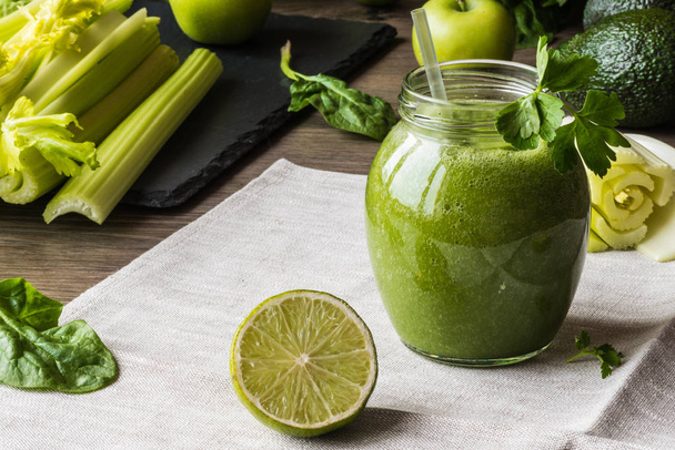 Detox diet. Green smoothie with different vegetables on wooden background - Foto, Imagen