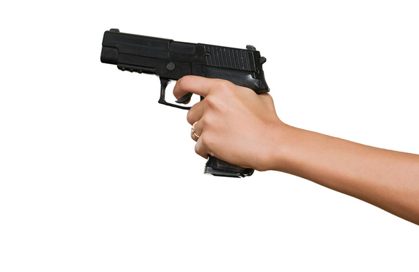 La mano de la mujer con un arma
 - Foto, imagen