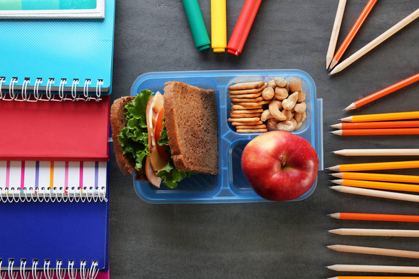 School lunch and stationery on table - Photo, image