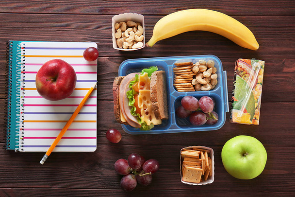 School lunch and stationery on table - Foto, imagen