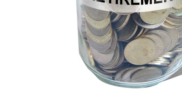 money into retirement fund jar isolated against white - Footage, Video