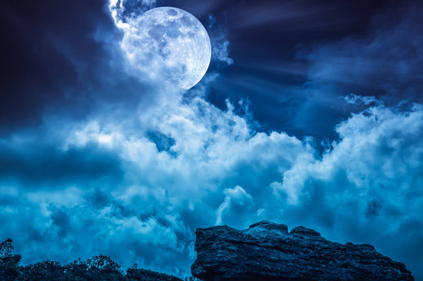 Boulder against blue sky with clouds and beautiful full moon at  - Photo, Image