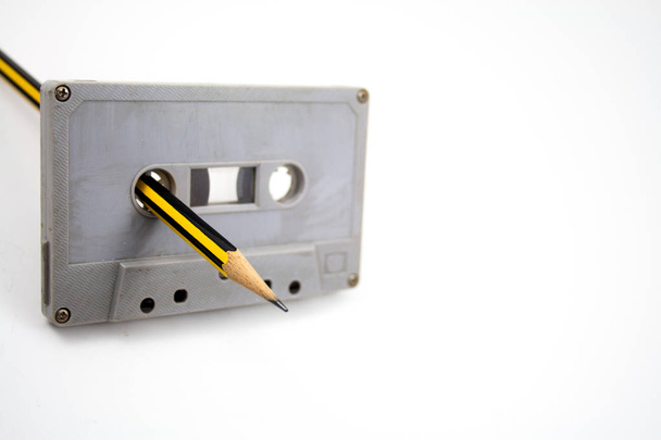 Selective focus, Cassette and pencil over the white background - Foto, afbeelding